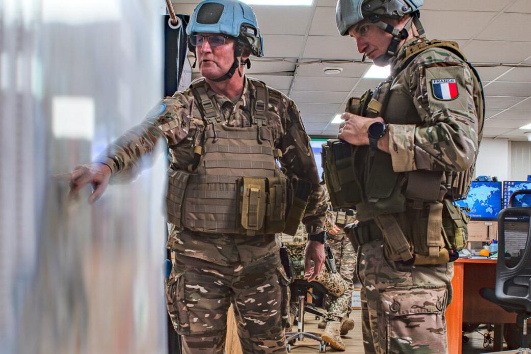 UN peacekeepers consult a map