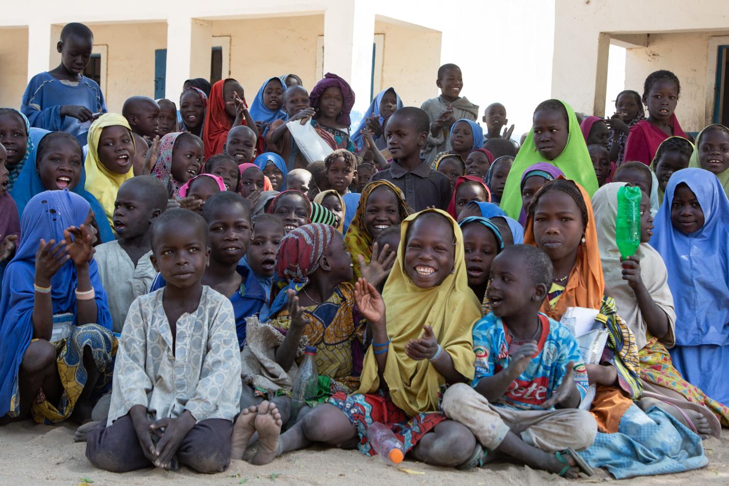 many children are sitting on the floor