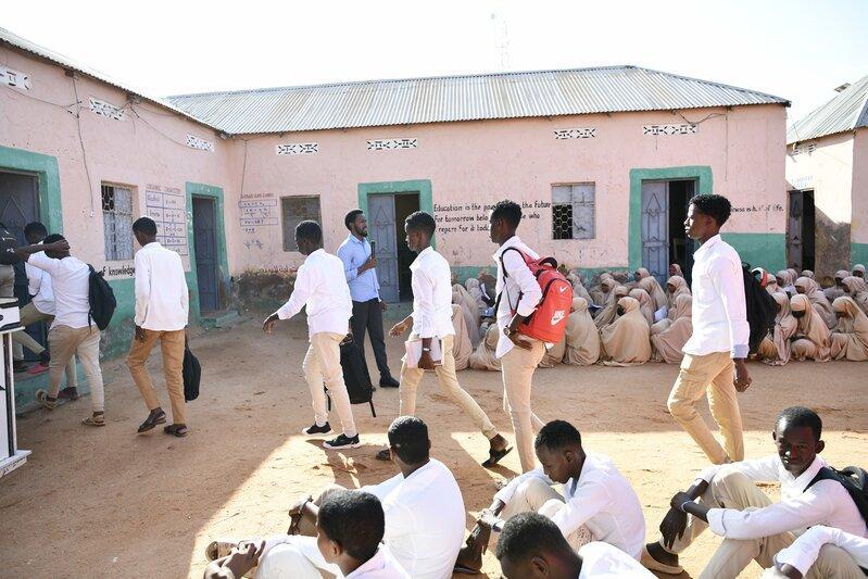Mohamed speaks to a large group of students