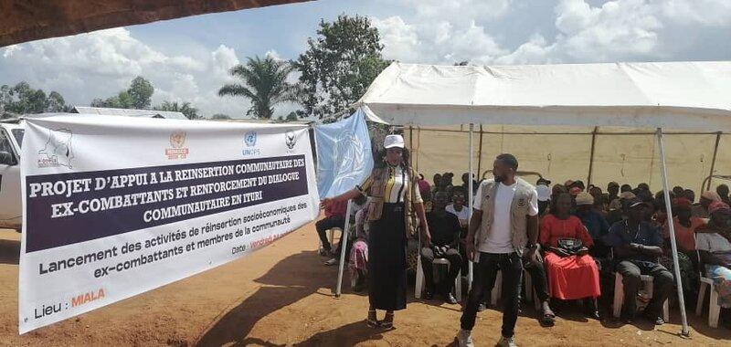 des personnes devant une banderole annonçant le lancement des activités