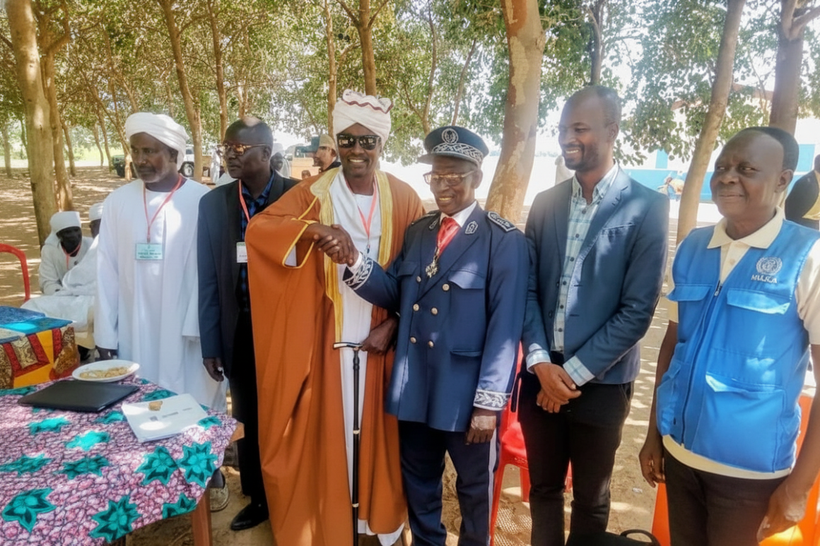 A group of officials stand in a row, smiling at the camera