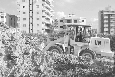Clearing debris from israeli bombardment of apartment building in tyre.